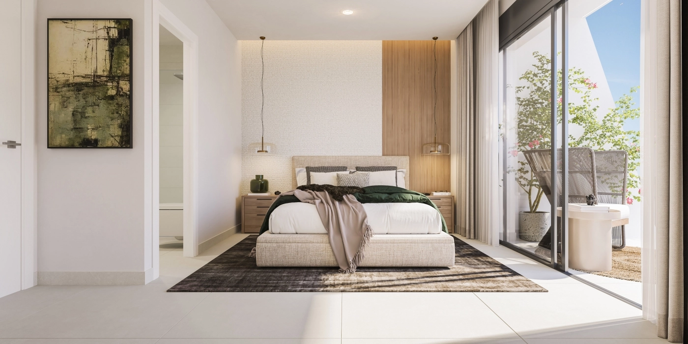 Das Hauptschlafzimmer ist ein ruhiger Rückzugsort, lichtdurchflutet und bietet direkten Zugang zu einer Außenterrasse.