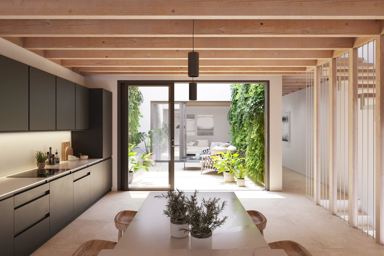 Die moderne Küche ist funktional gestaltet und öffnet sich zum zentralen Patio.