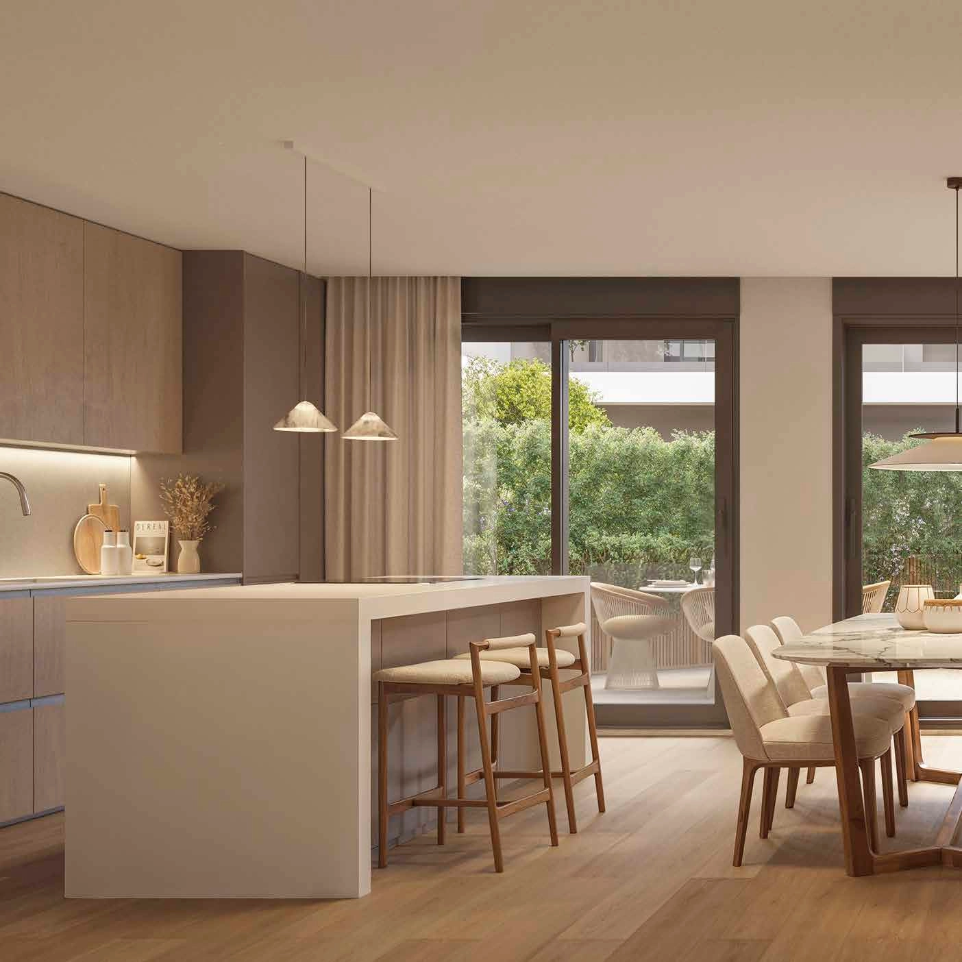 Eine moderne, hochwertige Küche, die sich zum Essbereich hin öffnet und sich perfekt für die Bewirtung von Gästen eignet.