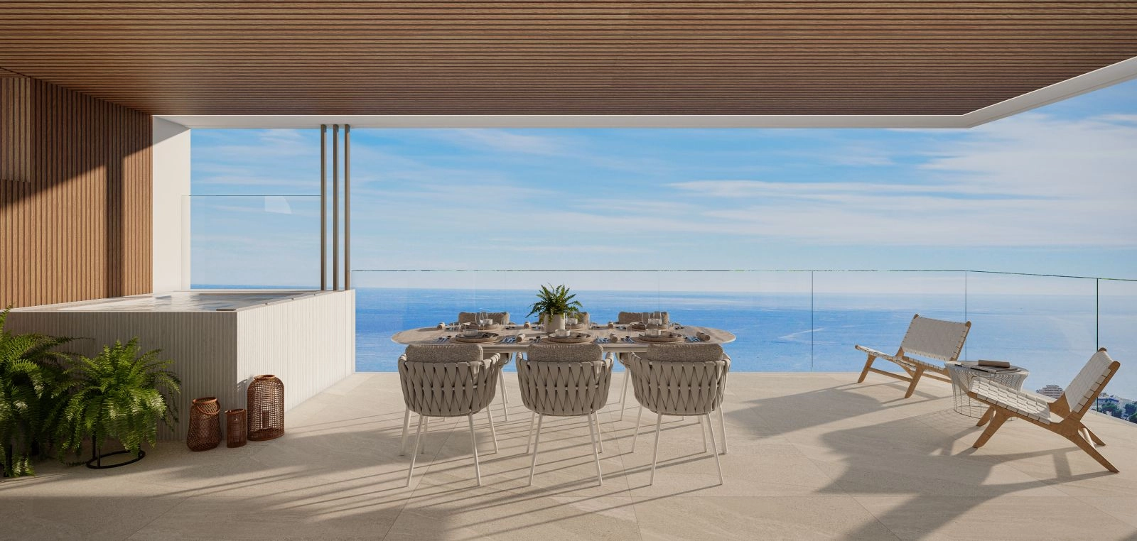 Eine geräumige private Terrasse mit Whirlpool, die einen herrlichen Meerblick über die Costa del Sol bietet.