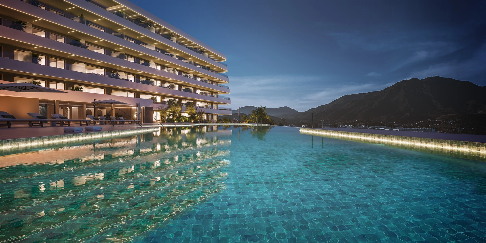 Der gemeinschaftliche Infinity-Poolbereich in der Abenddämmerung bietet einen ruhigen Ort zum Schwimmen und Entspannen mit Blick auf die Berge.