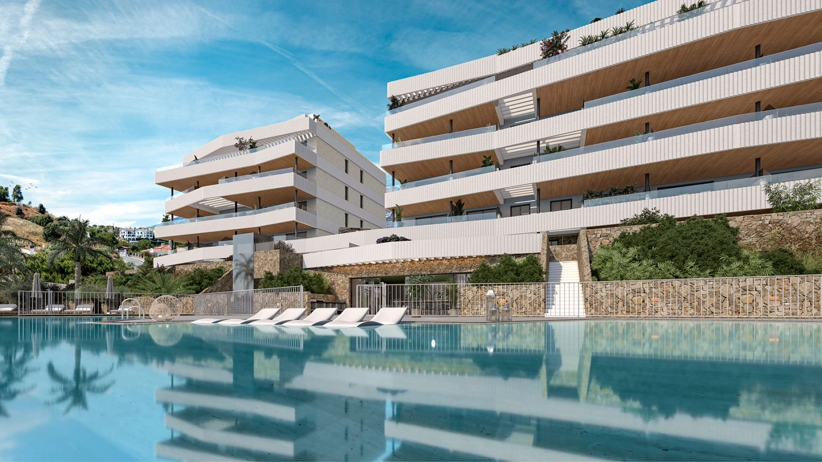 Der einladende Gemeinschaftspool und die Liegewiese, umgeben von moderner Architektur und üppigem Grün.