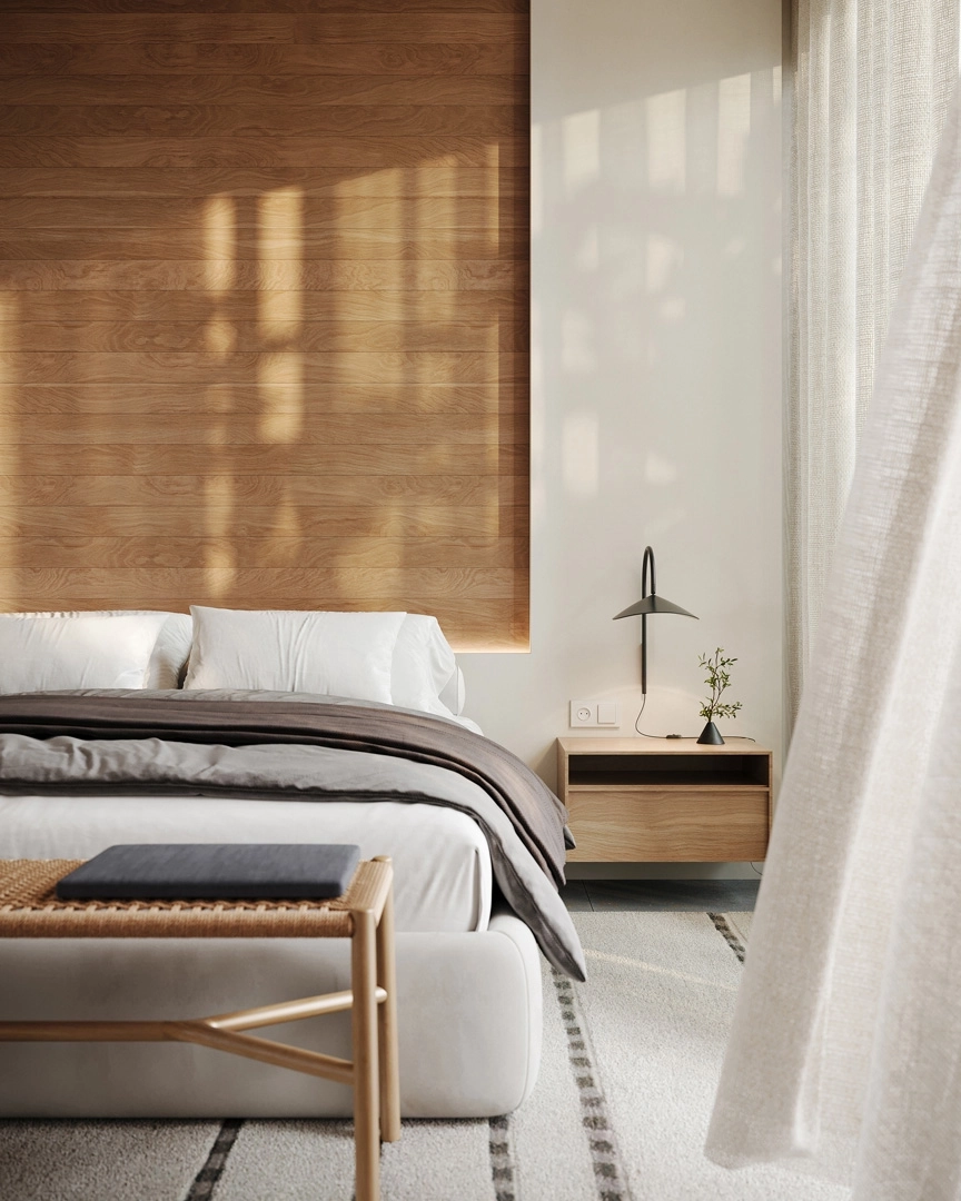 Das Hauptschlafzimmer ist ein ruhiger Rückzugsort, ausgestattet mit natürlichen Materialien und großen Fenstern, die das Morgenlicht hereinlassen.